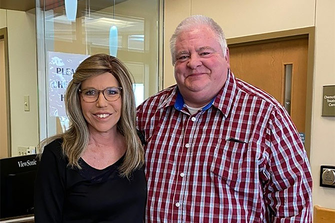 Ben in plaid shirt with woman in glasses