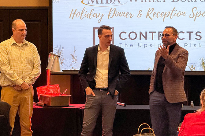 Three men giving presentation