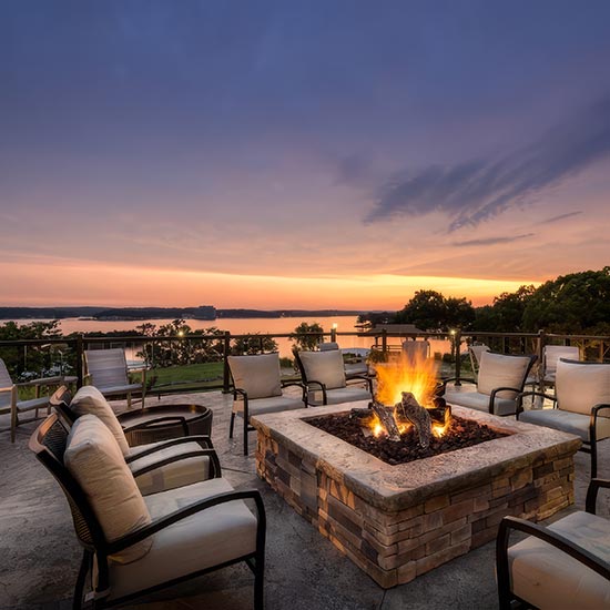 Convention preview - a square firepit with chairs around it and a beautiful sunset in the background