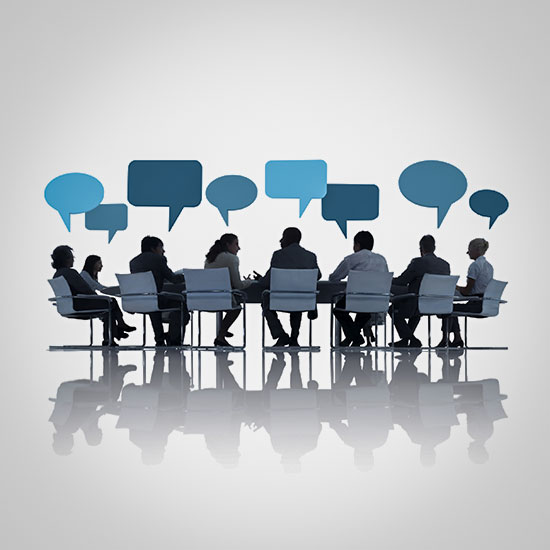 group sitting a a large table talking with word bubbles above their heads