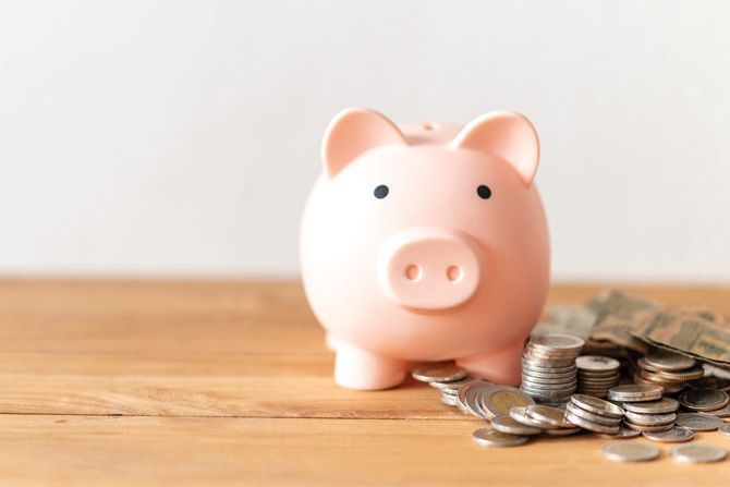 Piggy-bank-with-coin-on-wood-table